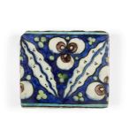 A Damascus Iznik border tile, 16th century, of rectangular form, the cobalt-blue ground decorated