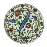 An Iznik pottery dish, Turkey, 17th century, of shallow rounded form on a short foot with everted