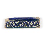 A Damascus border tile, late Mamluk, 16th century, of rectangular form, the cobalt ground