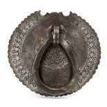 A Qajar engraved steel door knocker, Iran, 19th century, of circular form with crenellated edges,