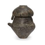 A Villanovan impasto ware biconical urn and lid, circa 9th-8th Century B.C., of burnished black