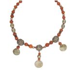 A silver and carnelian bead necklace, Yemen, late 18th-19th century, with silver coin attachments,