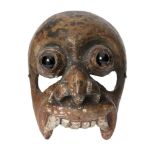 A wooden mask of demon Aturu Yaka, Ceylon (Sri Lanka), circa 1900, with black glass bulbous eyes,