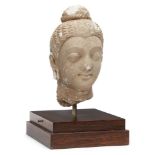A Gandhara stucco head of a Buddha, Afghanistan, 3-4th century, with serene expression, with bow-
