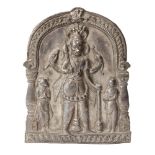 A silver repousse votive plaque with Shiva and attendants, India, 18th century, set within an arch