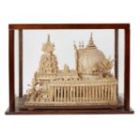 A balsa wood model of a temple, India, 19th century, in a wood and glass case, case 51.5cm. diam.