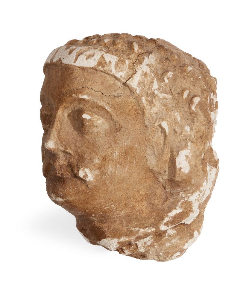 A Gandharan stucco head of a moustachioed man, Afghanistan, 2nd-3rd century, 9.5 x 8x 8.5 cm