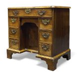 A George I walnut kneehole desk, the rectangular top above frieze drawer and blind frieze drawer