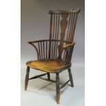 An elm and beech Windsor armchair, second half 19th Century, with shaped crest rail, above shaped