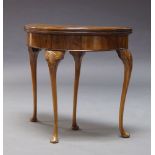 A Queen Anne style figured walnut demi-lune card table, first quarter 20th Century, the fold over