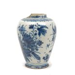 A tin glazed earthenware blue and white jar, probably 18th century, decorated with flowers, damages,