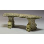A composite stone bench, late 20th Century, with curved seat on two scrolling pedestal bases, 45cm