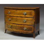 A George III mahogany and rosewood bow fronted chest of three long drawers, raised on splayed