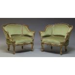 A pair of Louis XV style green upholstered bergère armchairs, first half 20th Century, each with