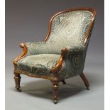 A Victorian mahogany framed armchair, with curved back, above scrolling arms, upholstered in green