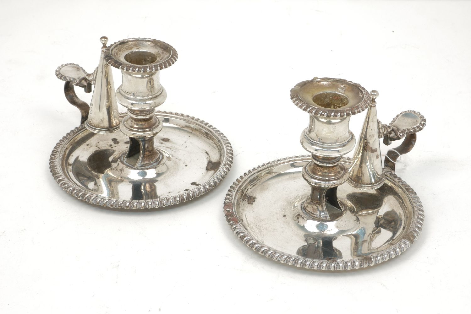 A pair of Georgian silver chamber sticks, Sheffield, c.1824, John and Thomas Settle, the circular