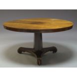 A Regency rosewood tilt top dining table, the circular top, on tapering octagonal column support, to