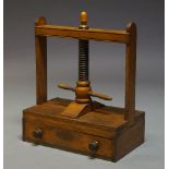 A Victorian mahogany book press, with acorn finial above a turned screw mechanism, over single