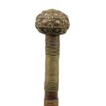 A tribal ceremonial hardwood staff, 20th century, applied with bands of brass and copper wire