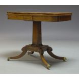 A Regency rosewood and brass inlaid, card table, the fold over top enclosing circular red baize