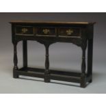 A George II style oak dresser base, 20th Century, with three frieze drawers, on front turned