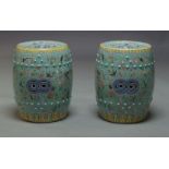 A pair of Chinese green ground porcelain garden seats, each of barrel shape, the sides and top