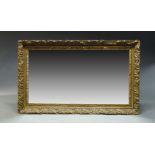 A large gilt overmantle mirror, second half 20th Century, of rectangular form, with scrolling