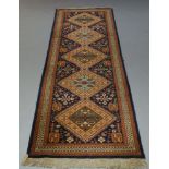 A runner with five medallions, 325cm x 101cm, along with two modern rugs and a patchwork quilt (4)