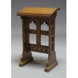 A Gothic oak prayer lectern, early to mid 20th century, the sloped top, raised on shaped end
