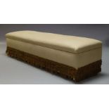 A large cream upholstered banquette, 20th Century, the hinged lid enclosing storage space within,