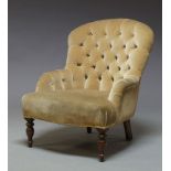 A Victorian button back nursing chair, upholstered in fawn colored velvet upholstery, raised on