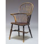 A Victorian ash and yew wood Windsor armchair, with hooped spindle back, above saddle seat on turned