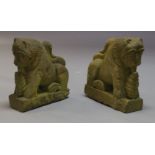 A pair of stylised carved stone lions, 20th Century, raised on plinth bases, each 49cm high (2)200