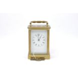 A brass carriage clock by Joseph Soldano, the white enamel dial with roman numeral chapter ring, the