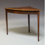 A George III mahogany bow fronted corner table, the top with a boxwood strung edge above a chequer