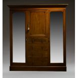 An Edwardian mahogany and inlaid triple wardrobe, the moulded cornice above cupboard door and four