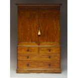 A Victorian mahogany linen press, the moulded cornice above two paneled cupboard doors, enclosing
