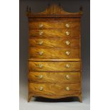 A Regency mahogany bow fronted chest on chest, the shaped cornice surmount with urn finials, above