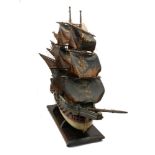 A polychromed wooden model of a four mast galleon, 20th century, on a wooden stand, 70cm high100