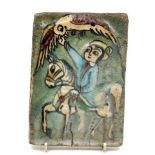 A Persian tile, late 19th/20th century, decorated with a man on a horse with a hawk in his hand,