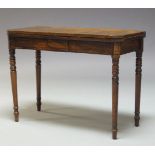 A George III mahogany and line inlaid card table, the fold over top enclosing green baize lined