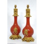 A pair of gilt bronze and red porcelain senumbra lamps, 19th century, later converted to