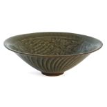 A Chinese Yaozhou conical bowl, carved in low relief to the interior with two entwined flowering