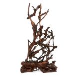 A Chinese abstract rootwood sculpture, late Qing dynasty, carved with branches of blossoming prunus,