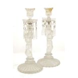 A pair of early 20th century caryatid glass candlesticks with glass droppers, together with a