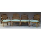 Four Louis XV style beech and caned fauteuils, 20th Century, the shaped backrest with floral
