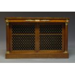 A French Empire mahogany and gilt metal mounted credenza, with two pierced brass lattice work doors,