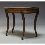 A Regency mahogany fold over tea table, on fluted sabre supports, 75cm high, 92cm wide, 46cm deep,