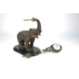 A spelter elephant mystery clock, late 19th/early 20th century, the elephant depicted standing on