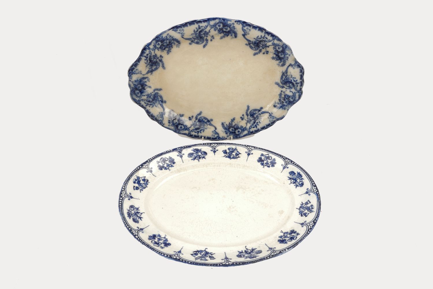 Four large Staffordshire oval shaped meat platters with various blue and white printed patterns of